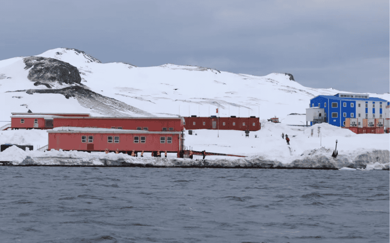 Arctic Prefabricated Buildings - A row of red buildings in a snowy Antarctic environment, likely serving as research stations or temporary shelters.