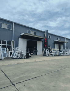 Exterior view of a steel structure building with windows and doors added, showcasing its functionality and versatility.