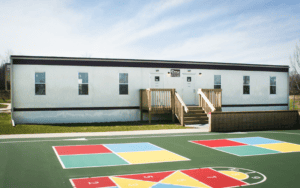 This is a portable classroom in front of the playground.