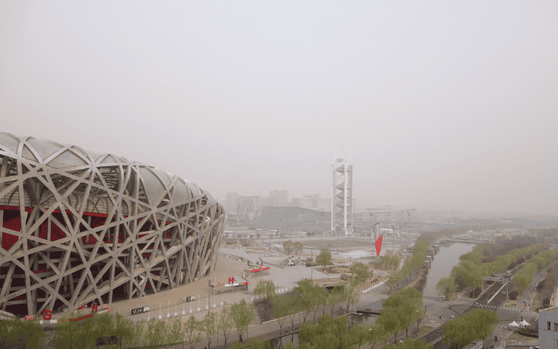 A view of the iconic Beijing National Stadium (Bird's Nest), designed for the 2008 Olympics, showcasing its intricate steel structure and modern design.