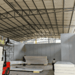 Construction of a Cold Storage Building with white insulation panels and a steel frame.