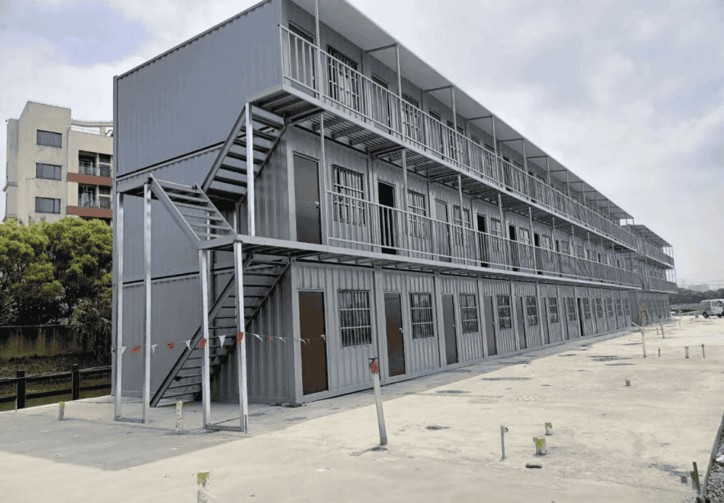 Three-story container barracks with external staircases and balconies, designed for efficient and compact accommodation in industrial settings.