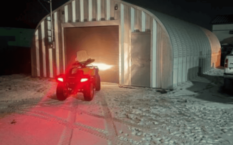 vehicle on frozen ground entering steel garage