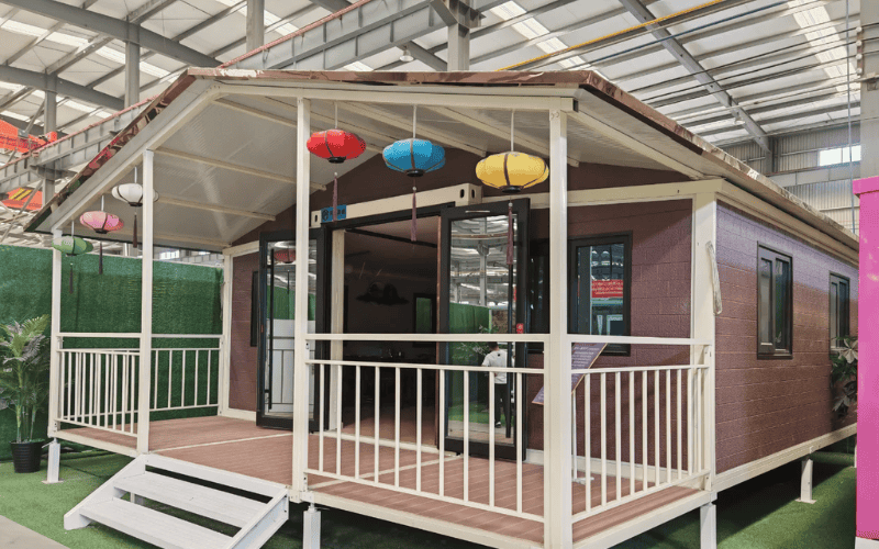 Modern portable classroom with vibrant lanterns and a welcoming porch, showcasing its functional and stylish design.