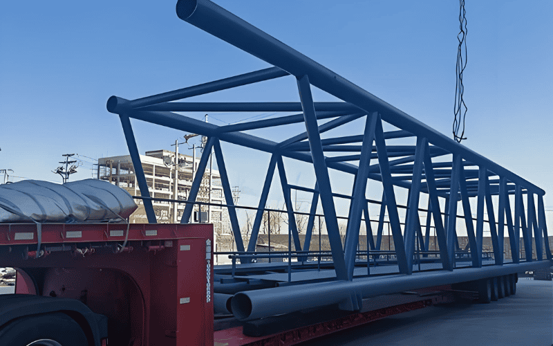 A light gauge steel truss structure being transported on a truck.