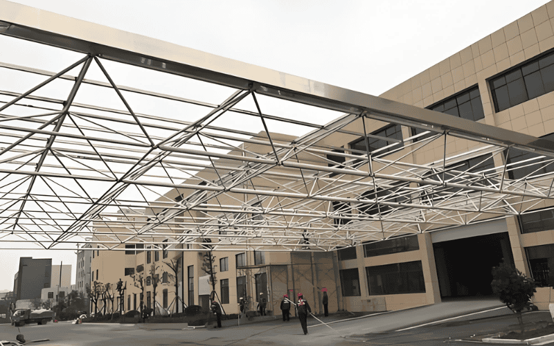 A light gauge steel canopy structure over a building entrance.