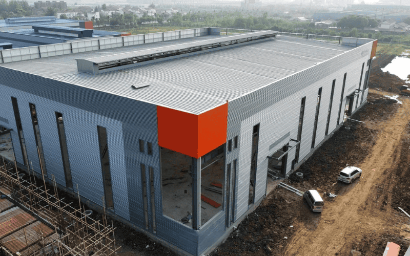 A completed industrial building with light gauge steel structure and metal cladding.