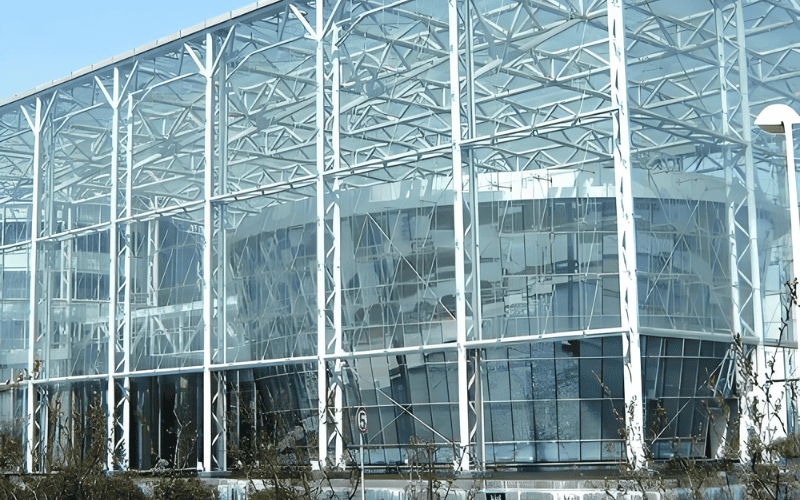 a steel frame structure with a glass facade