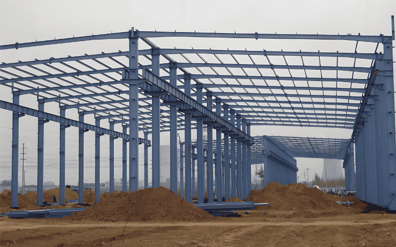 A large blue heavy duty steel structure under construction