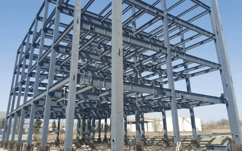  A multi-level steel building under construction, showcasing a grid-like arrangement of steel beams and columns.