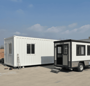 A modular home and a trailer home placed side by side, highlighting the difference in structure with the modular home having a more traditional design and the trailer home being on wheels.