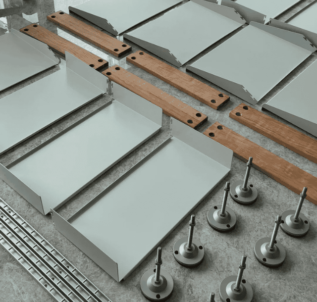 Flat layout of modular home components including metal panels, wood beams, and fasteners, illustrating modular house prefabrication process.