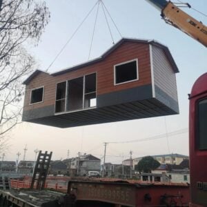 Modular building construction site with crane lifting prefabricated container unit into place