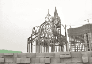 A partially constructed Prefab Steel Church Building with a skeletal steel frame, featuring an arched design and a clock tower in progress.