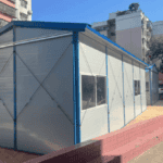 Blue-framed temporary housing structure with multiple windows, blending practicality and durability for urban settings.