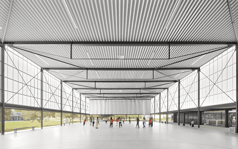 Indoor steel skating rink featuring a corrugated metal ceiling and people walking around.