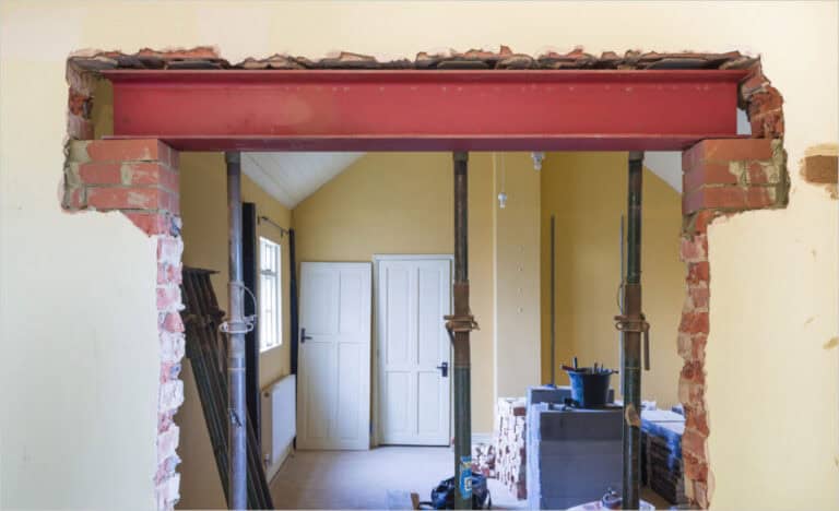 Steel beam supporting a load-bearing wall during interior renovation