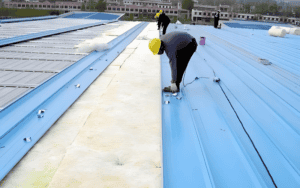 There are some workers are doing insulation for the steel building.