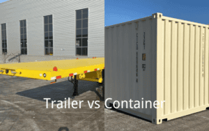 A yellow flatbed trailer and a beige shipping container side by side on a concrete surface, with the text "Trailer vs Container" overlaying the image, set against an industrial building backdrop.