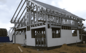 A light steel structure under construction, featuring exposed steel frames and partially installed wall panels, showcasing its modern and durable design.