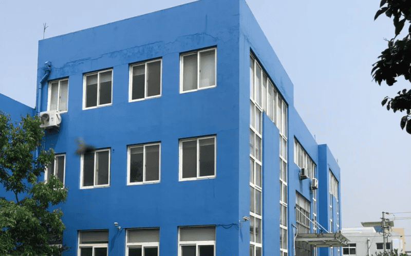 a bright blue, multi-story industrial building