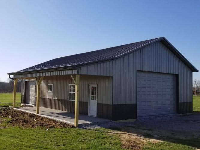 barndominium with a porch and garage door