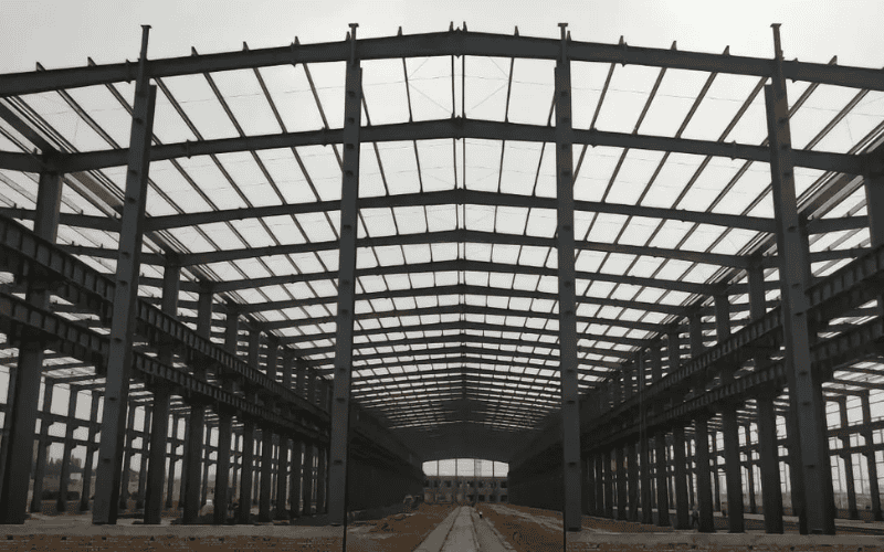 The front view of a completed steel frame warehouse with clear span areas and symmetrical design.