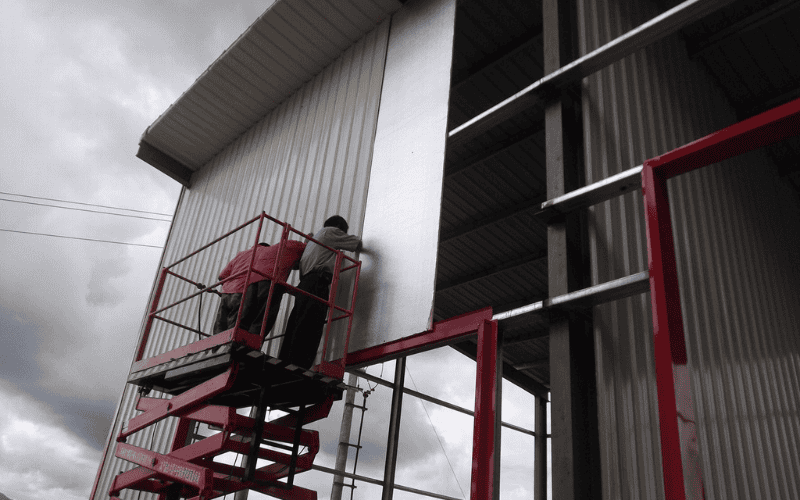 installing insulation panels on a steel building