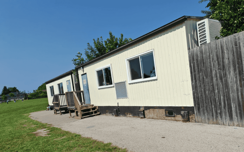 Classic portable classroom with simple design and a straightforward exterior, showing its practical use in educational environments.