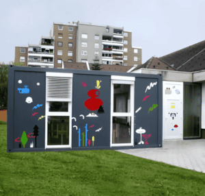 Decorative container-style portable classroom with bold graphic artwork on the exterior, providing a creative space for learning.