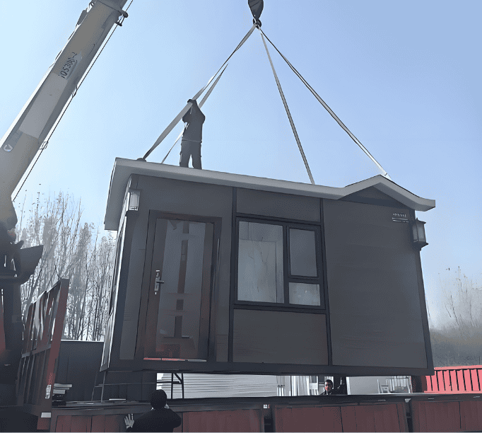 A modular home being lifted with a crane, showcasing the construction process as it is placed onto its foundation.