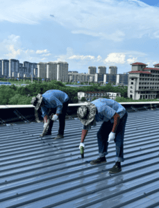 workers installing steel roof panels