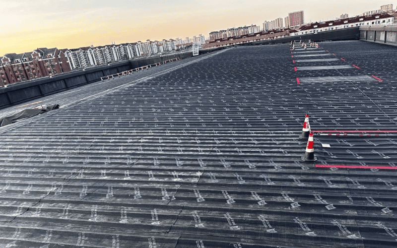 Roof installation with safety cones and markings