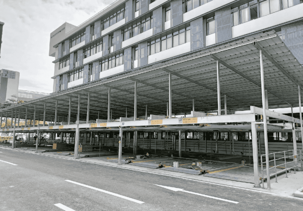 The prefab steel garage parking structure with visible support beams.