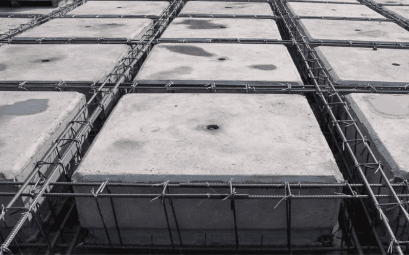 A concrete hollow block slab reinforced with a metal grid, showing a construction process designed for structural stability.