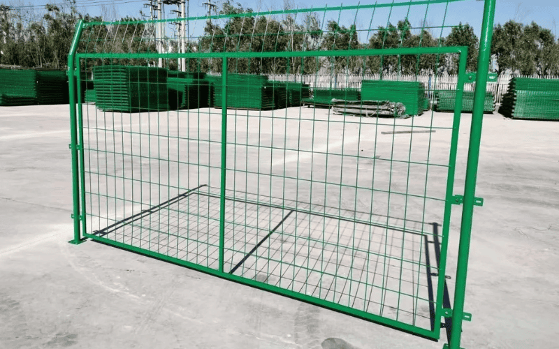 Green-painted metal fence gate with grid design, suitable for perimeter security and industrial usage.